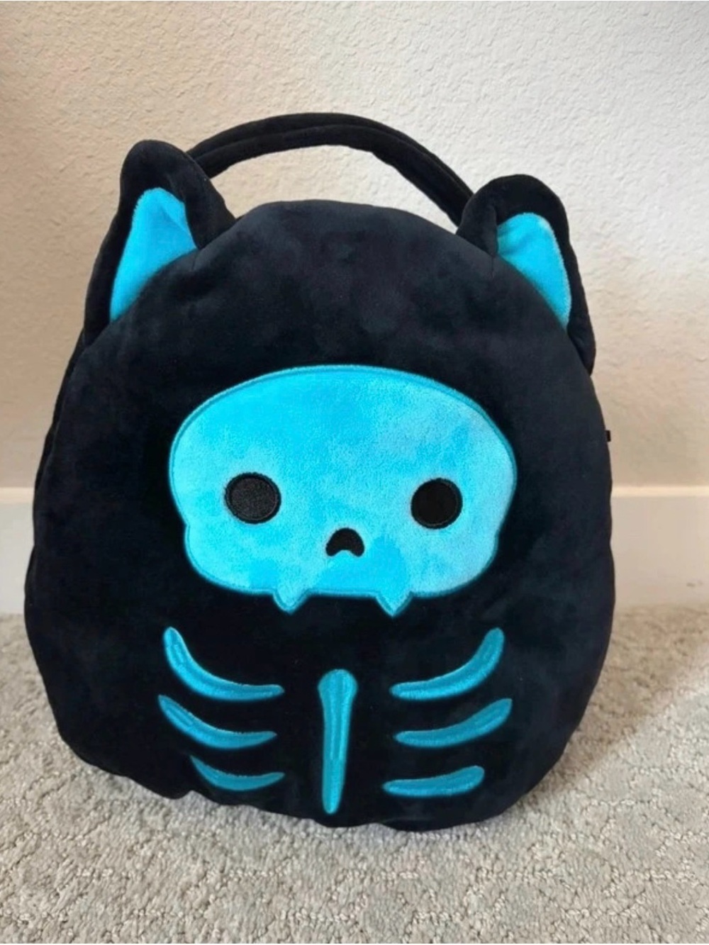 Squishmallows Black Plush Trick-or-Treat Bag with Bright Blue Skeleton Cat Face